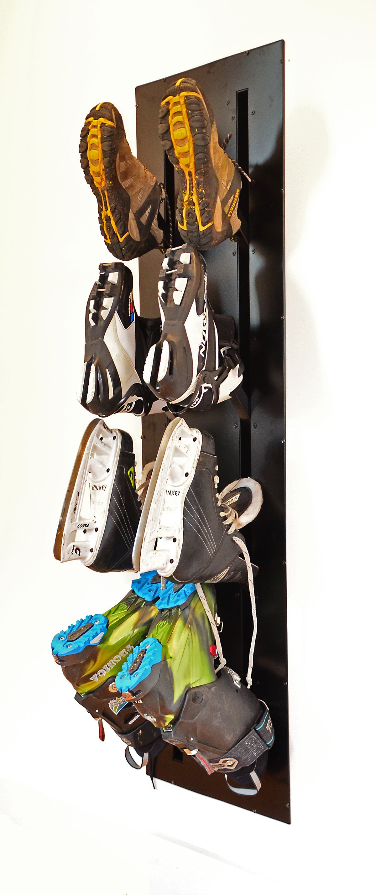 Ski boot dryer mounted in a wall and loaded with ski boots and skates. For instalation in ski chalet or any mudroom.