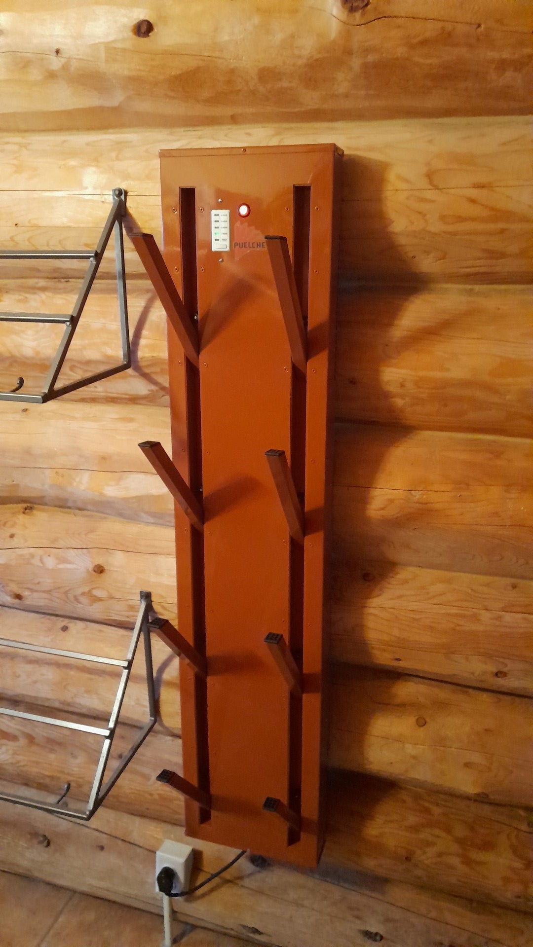 Wall mounted stainless steel boot dryer for 4 pairs. Show open,, painted copper colored. Mounted on log wall.