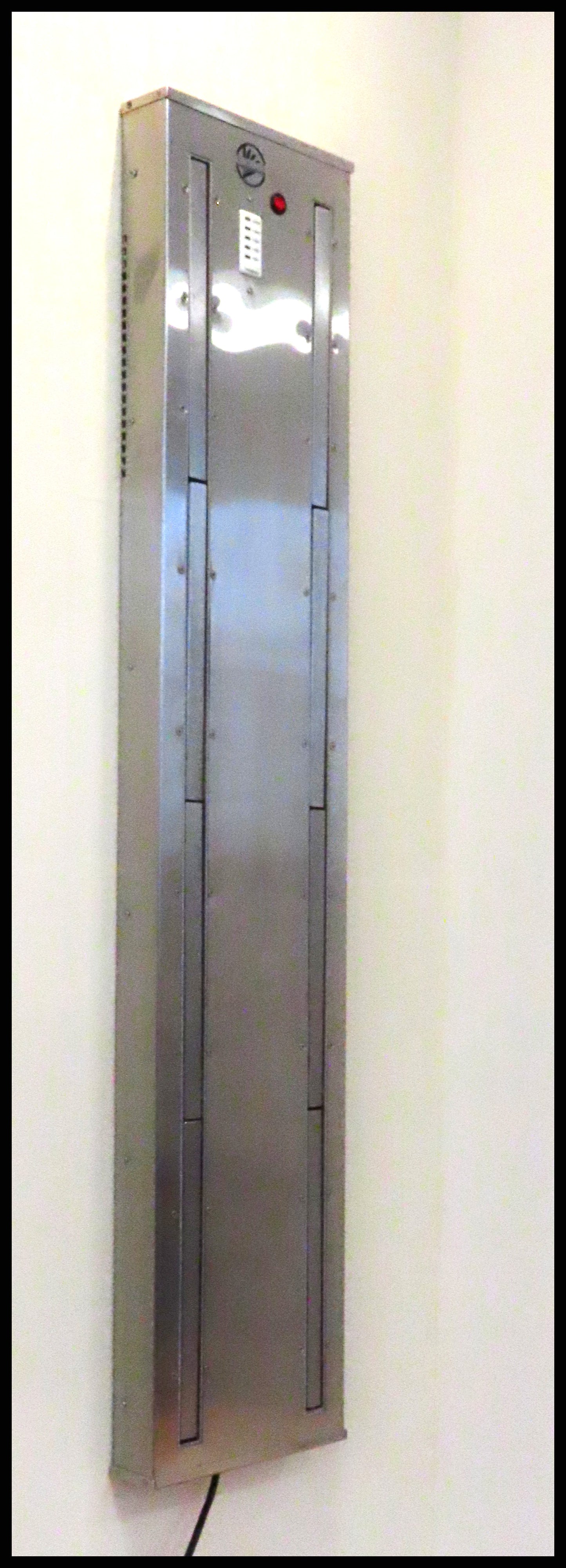 Wall mounted Boot Dryer wall mount. Four pair stainless steel. Warm or ambient air. Attractive space saving design best for ski homes , condos and any mudroom. Timer controlled dryer for ski boots, skates, gloves. Shown with pegs closed. From Puelche dryer